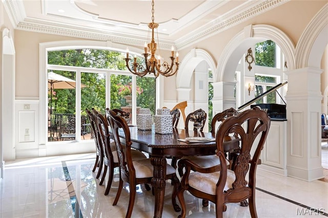dining room featuring a decorative wall, inlaid floor details, a chandelier, healthy amount of natural light, and ornamental molding