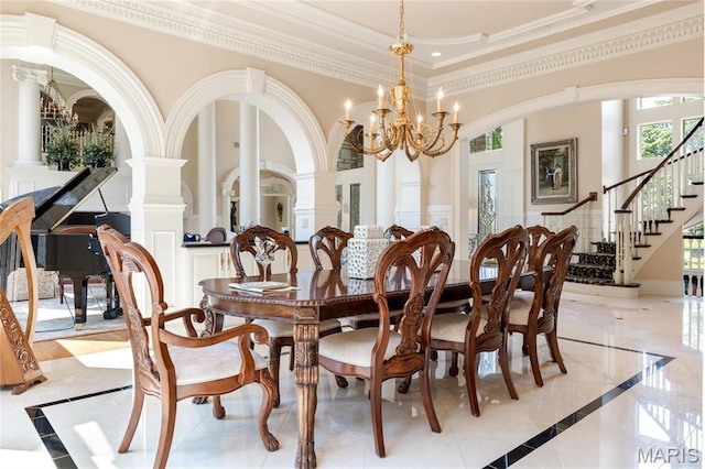 dining area with inlaid floor details, ornamental molding, stairs, a chandelier, and a high ceiling