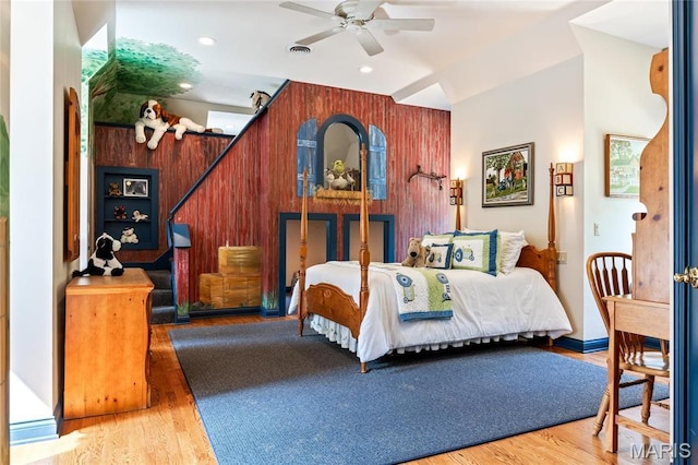 bedroom with wood finished floors, recessed lighting, wooden walls, and a ceiling fan