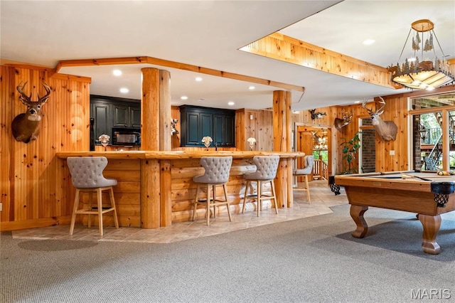 rec room featuring light colored carpet, wooden walls, recessed lighting, billiards table, and bar