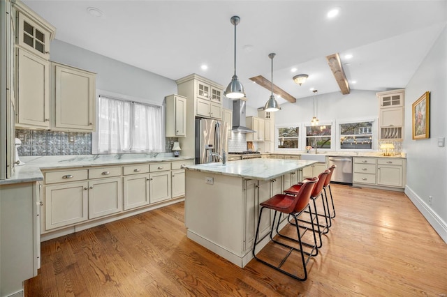 kitchen featuring wall chimney exhaust hood, appliances with stainless steel finishes, plenty of natural light, tasteful backsplash, and recessed lighting