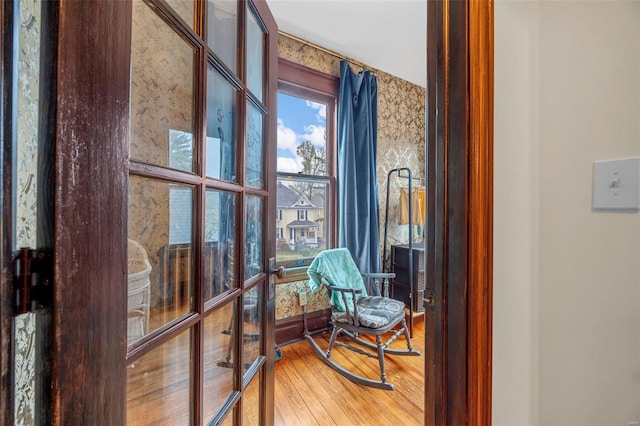 sitting room with wood finished floors and french doors
