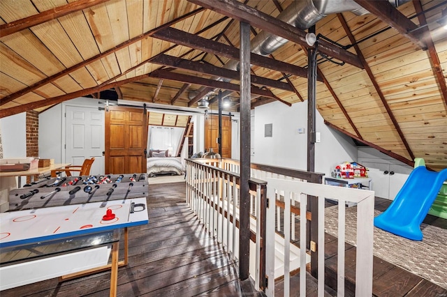 playroom featuring wood-type flooring, wooden ceiling, and a barn door