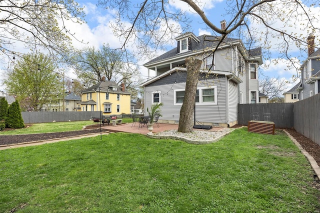 rear view of property with a patio area and a chimney