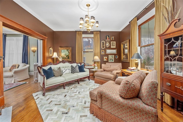 living area featuring a chandelier, wood finished floors, and crown molding