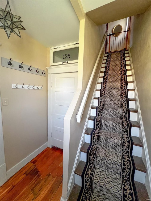 staircase with wood finished floors