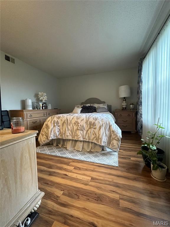 bedroom featuring dark wood finished floors