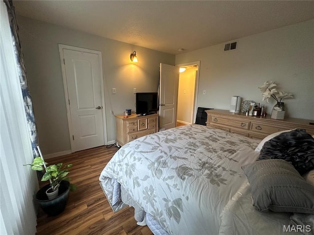 bedroom with wood finished floors and baseboards
