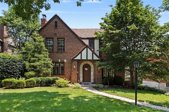 46 Broadview Dr, Clayton, MO 63105 - tudor home with brick siding, a chimney, and a front lawn
