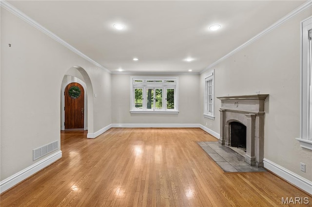 46 Broadview Dr, Clayton, MO 63105 - unfurnished living room featuring wood-type flooring, ornamental molding, a tiled fireplace, recessed lighting, and arched walkways