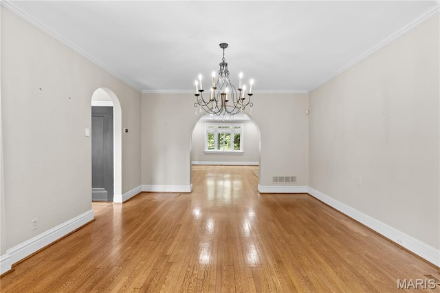 46 Broadview Dr, Clayton, MO 63105 - spare room featuring arched walkways, light wood-style floors, a chandelier, and crown molding
