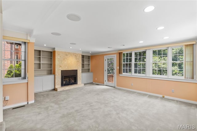 46 Broadview Dr, Clayton, MO 63105 - unfurnished living room featuring carpet, a high end fireplace, recessed lighting, ornamental molding, and built in shelves
