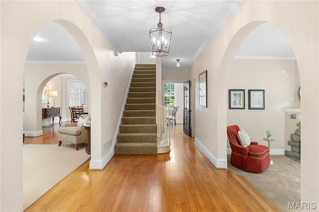 46 Broadview Dr, Clayton, MO 63105 - entrance foyer with stairway, light wood-type flooring, crown molding, and a chandelier