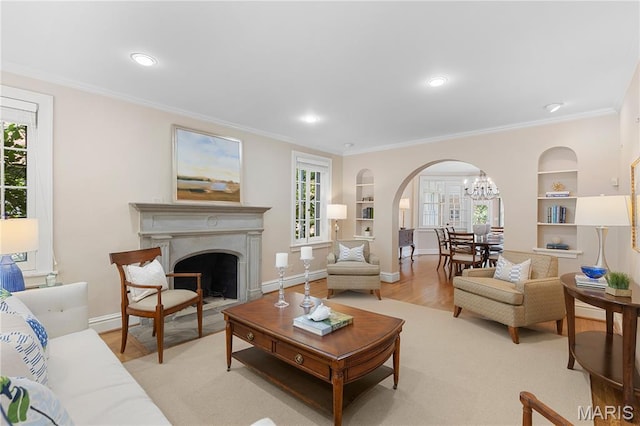 46 Broadview Dr, Clayton, MO 63105 - living area with arched walkways, built in features, healthy amount of natural light, crown molding, and a fireplace