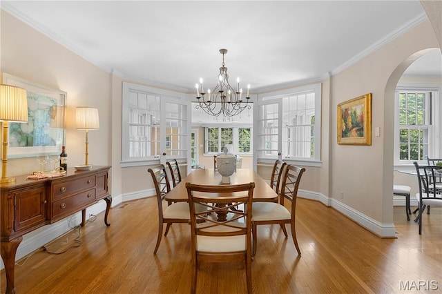 46 Broadview Dr, Clayton, MO 63105 - dining space featuring arched walkways, a chandelier, light wood-style flooring, and crown molding