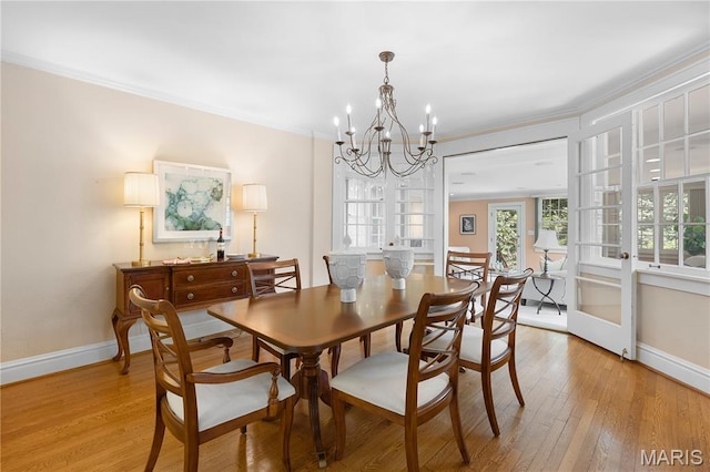 46 Broadview Dr, Clayton, MO 63105 - dining space with a chandelier, light wood-type flooring, and crown molding
