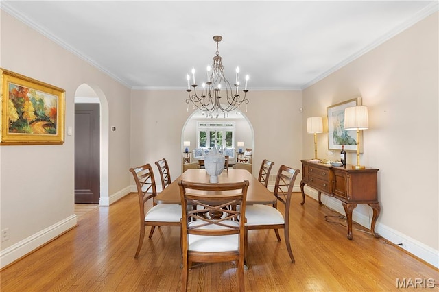 46 Broadview Dr, Clayton, MO 63105 - dining space with arched walkways, light wood finished floors, ornamental molding, and a chandelier