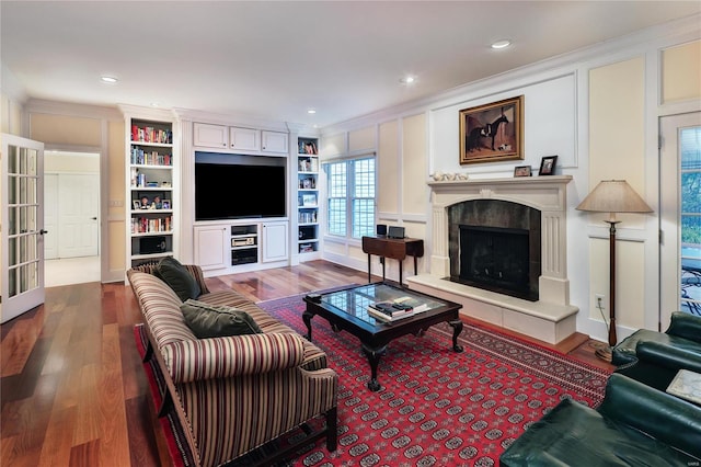 14643 Chermoore Dr, Chesterfield, MO 63017 - living area with wood finished floors, a tile fireplace, ornamental molding, a decorative wall, and french doors