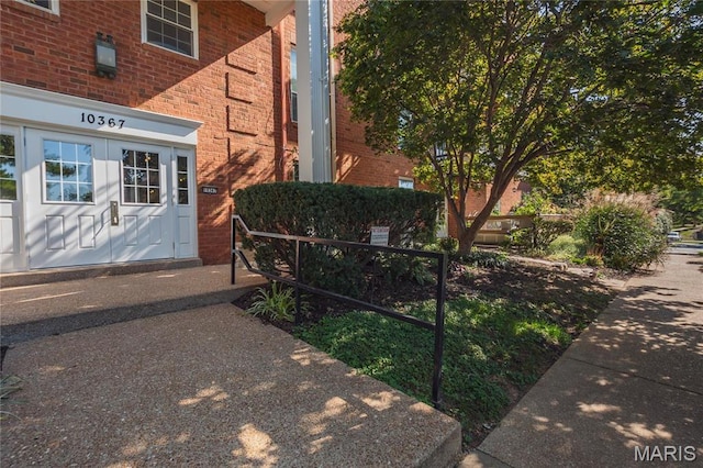 entrance to property featuring brick siding