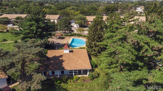aerial view of property and surrounding area featuring a pool area