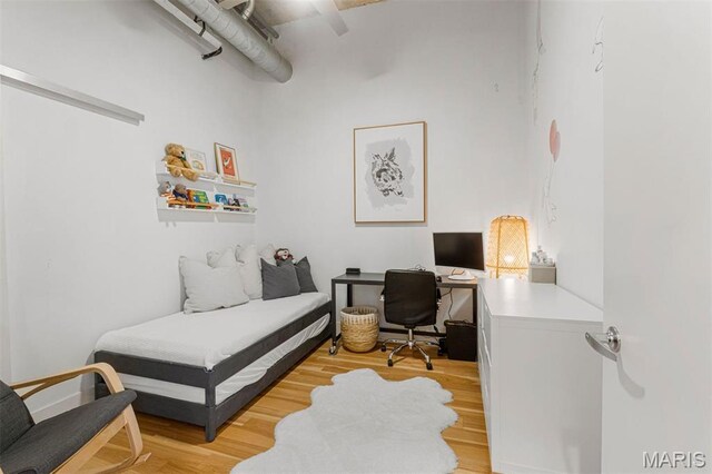 4100 Forest Park Ave Unit 403, Saint Louis, MO 63108 - bedroom with an office area and light wood-style flooring