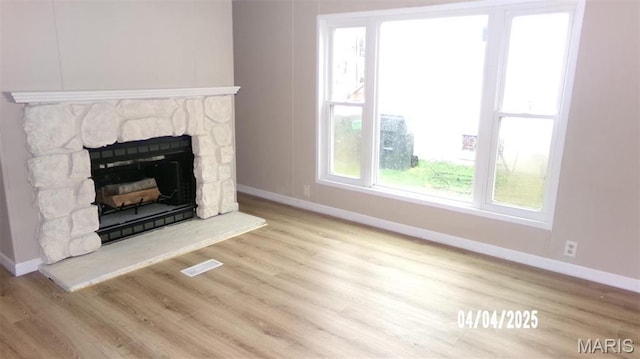610 E Green St, Mascoutah, IL 62258 - unfurnished living room with baseboards, wood finished floors, and a fireplace