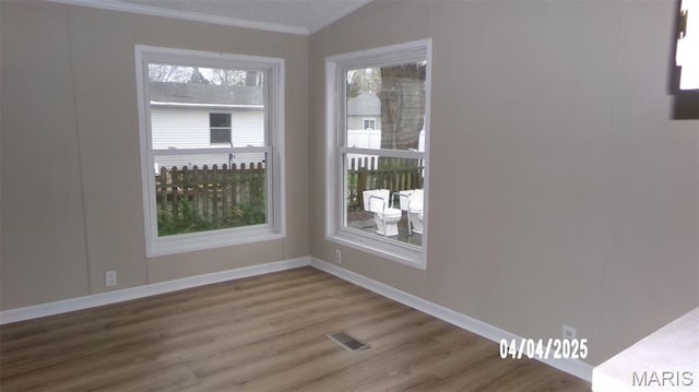 610 E Green St, Mascoutah, IL 62258 - spare room featuring ornamental molding, wood finished floors, and baseboards