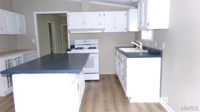 610 E Green St, Mascoutah, IL 62258 - kitchen with white gas range, under cabinet range hood, a sink, dark countertops, and white cabinetry