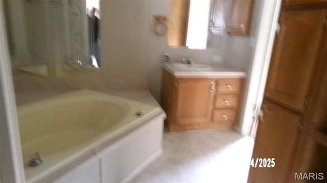 610 E Green St, Mascoutah, IL 62258 - bathroom featuring a garden tub and vanity