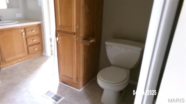 610 E Green St, Mascoutah, IL 62258 - bathroom featuring tile patterned flooring, toilet, and vanity