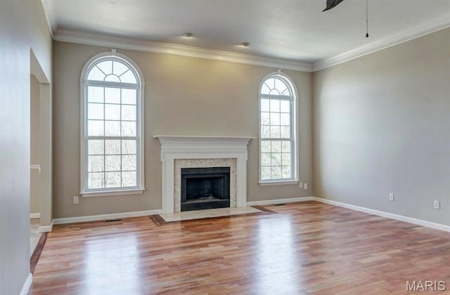 911 Valse Ct, Lake St Louis, MO 63367 - unfurnished living room with wood finished floors, baseboards, a high end fireplace, and ornamental molding