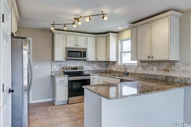 911 Valse Ct, Lake St Louis, MO 63367 - kitchen featuring stainless steel appliances, a sink, a peninsula, tasteful backsplash, and light stone counters