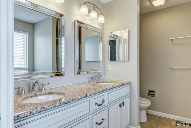 911 Valse Ct, Lake St Louis, MO 63367 - bathroom with toilet, tile patterned floors, double vanity, and baseboards