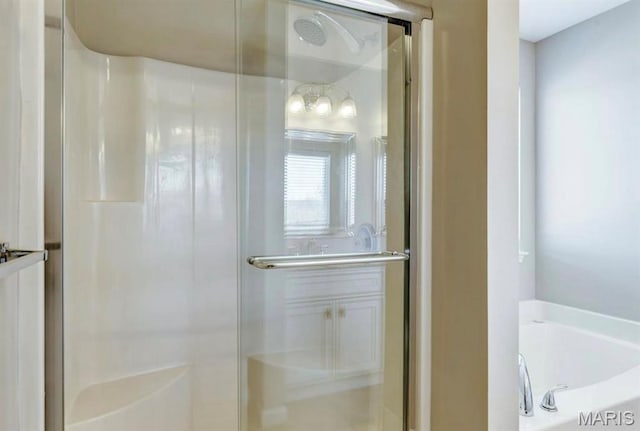 911 Valse Ct, Lake St Louis, MO 63367 - bathroom featuring a stall shower and a garden tub