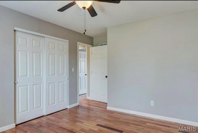 911 Valse Ct, Lake St Louis, MO 63367 - unfurnished bedroom with baseboards, light wood-type flooring, a closet, and a ceiling fan