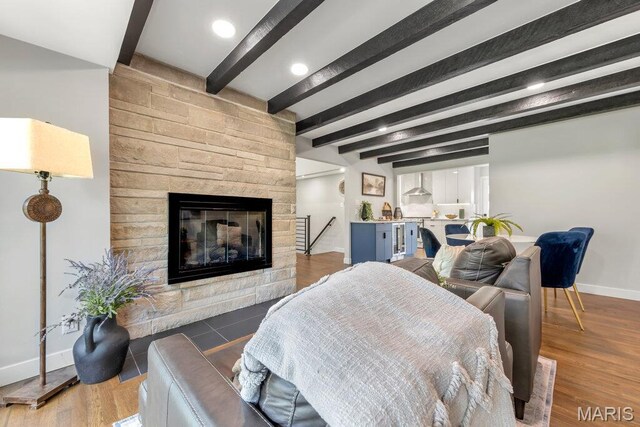 6 Cedar Crst, Saint Louis, MO 63132 - living room featuring beam ceiling, baseboards, a fireplace, and wood finished floors
