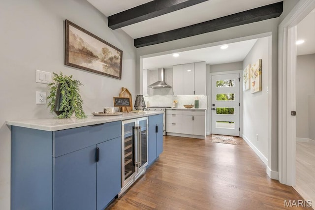 6 Cedar Crst, Saint Louis, MO 63132 - indoor bar featuring wall chimney range hood, wine cooler, light wood-type flooring, beamed ceiling, and range with gas cooktop