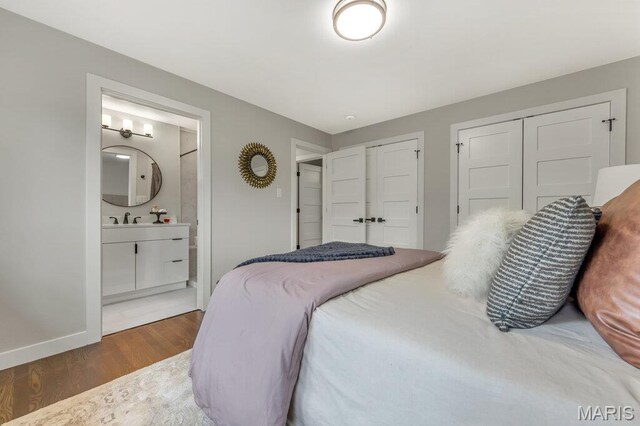 6 Cedar Crst, Saint Louis, MO 63132 - bedroom with multiple closets, wood finished floors, baseboards, a sink, and ensuite bath