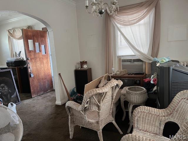 2412 Switzer, Saint Louis, MO 63136 - carpeted dining space featuring arched walkways, crown molding, cooling unit, and a chandelier