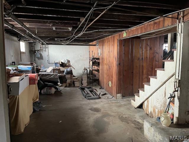 2412 Switzer, Saint Louis, MO 63136 - unfinished basement with stairway, wooden walls, and gas meter