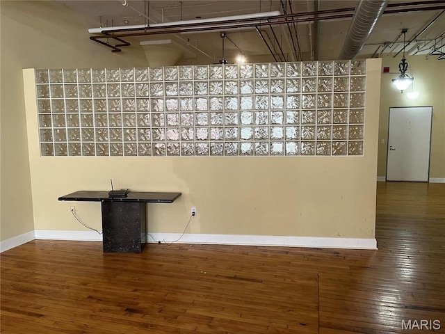 interior space featuring hardwood / wood-style floors and baseboards
