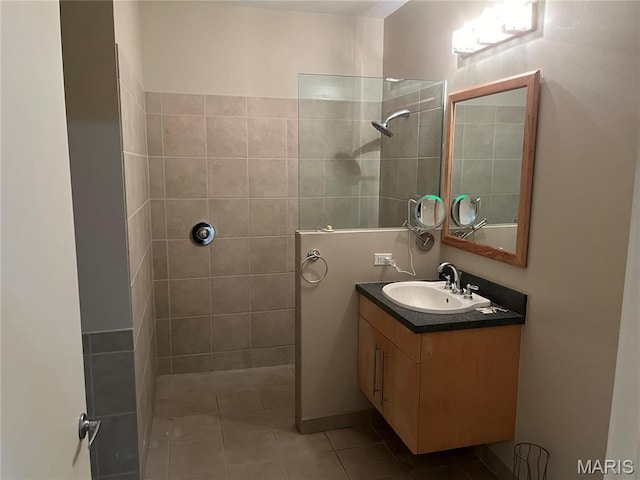 bathroom featuring walk in shower, vanity, and tile patterned floors