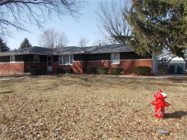 ranch-style home with brick siding and a front yard