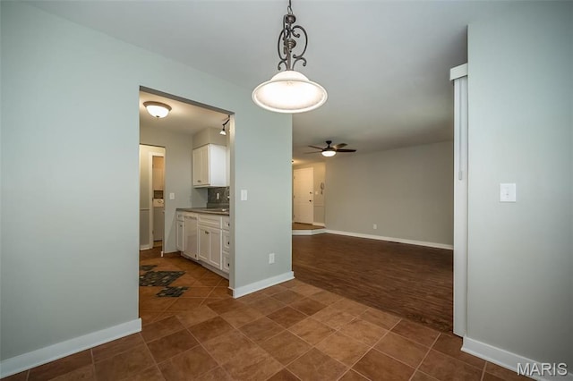 711 Lofty Point Dr Unit B, Ballwin, MO 63021 - unfurnished room featuring a ceiling fan, baseboards, and dark tile patterned flooring