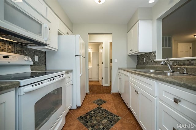711 Lofty Point Dr Unit B, Ballwin, MO 63021 - kitchen with white appliances, a sink, white cabinets, dark tile patterned floors, and tasteful backsplash