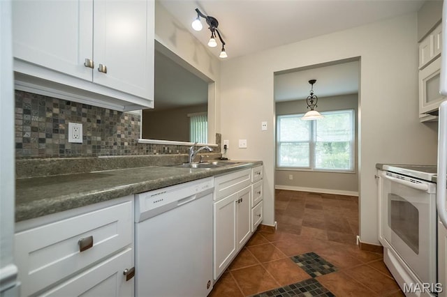711 Lofty Point Dr Unit B, Ballwin, MO 63021 - kitchen with white appliances, a sink, tasteful backsplash, dark countertops, and white cabinetry
