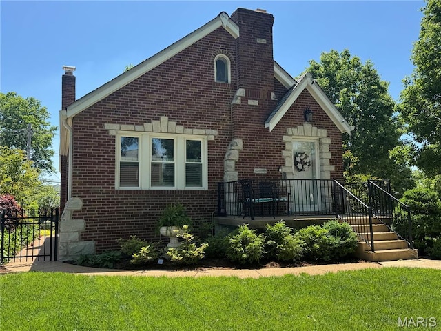 6060 Oleatha Ave, Saint Louis, MO 63139 - view of front of home featuring a chimney and brick siding