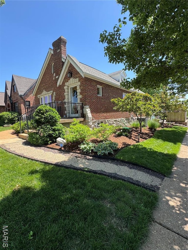 6060 Oleatha Ave, Saint Louis, MO 63139 - view of front facade featuring brick siding, a chimney, and a front lawn