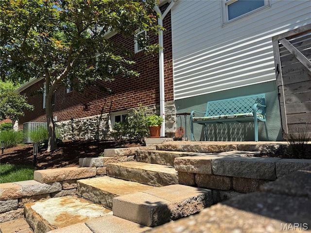 6060 Oleatha Ave, Saint Louis, MO 63139 - view of property exterior with brick siding and central air condition unit