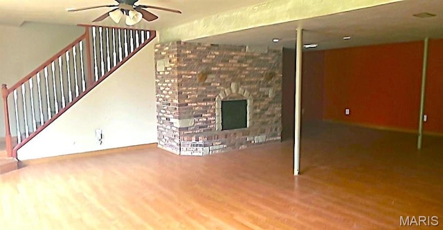 701 Deerfield Ct, Union, MO 63084 - unfurnished living room with a ceiling fan, wood finished floors, a fireplace, and stairs